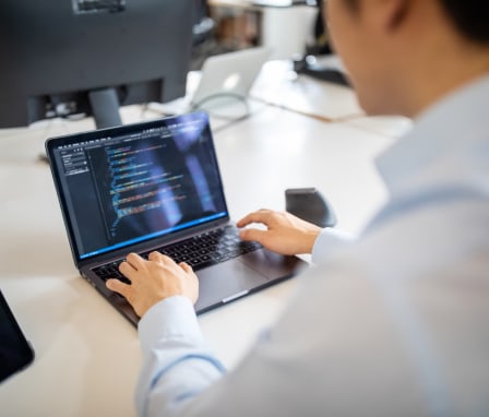 Man coding on laptop