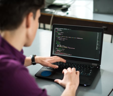 Man coding on laptop