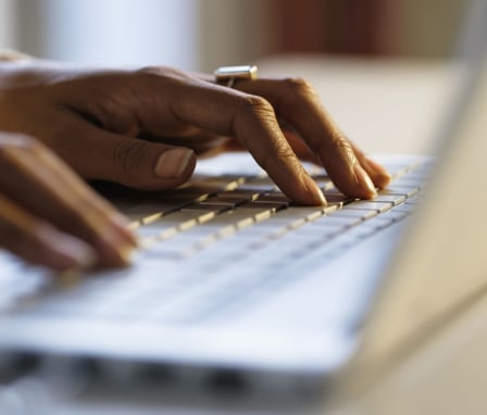 Hands typing on a keyboard